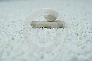 Pyramids of gray and white zen pebble meditation stones on white background. Concept of harmony