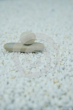 Pyramids of gray and white zen pebble meditation stones on white background. Concept of harmony