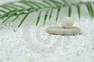 Pyramids of gray and white zen pebble meditation stones on white background. Concept of harmony