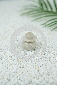 Pyramids of gray and white zen pebble meditation stones on white background. Concept of harmony