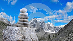 Pyramids of stones against the backdrop of mountains are a symbol of calm and balance. Zen meditation concept