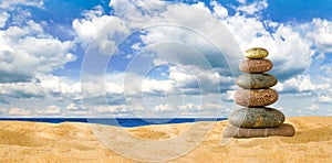 Pyramids of stones against the background of the sea are a symbol of calm and balance