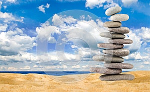 Pyramids of stones against the background of the sea are a symbol of calm and balance