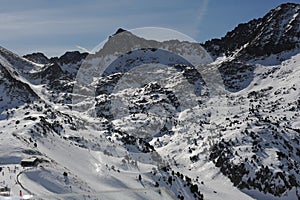 Pyrenees mountains range in winter with snowy peaks in Grandvalira ski paradise resort in Andorra