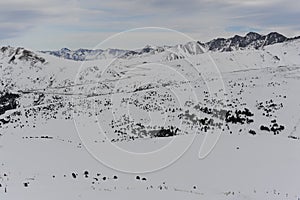 Pyrenees mountains range in winter with snowy peaks in Grandvalira ski paradise resort in Andorra