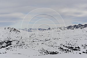 Pyrenees mountains range in winter with snowy peaks in Grandvalira ski paradise resort in Andorra