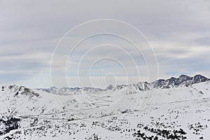 Pyrenees mountains range in winter with snowy peaks in Grandvalira ski paradise resort in Andorra