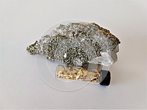 Pyrite, calcite minerals and gold leaf in bottle