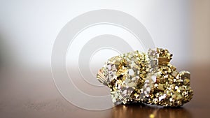 Pyrite stone natural gemstone on wooden table background selected focus