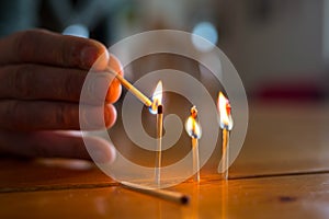 Pyromaniac man playing with burning matches