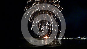 Pyrotechnics display over the beach at night. Bay.