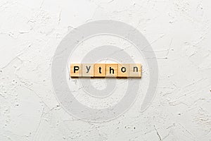 python word written on wood block. python text on table, concept