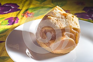 pÃ£o de queijo, cheese buns stuffed with dulce de leche in a white container, coy space and selective focus