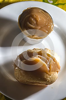 pÃ£o de queijo, cheese buns stuffed with dulce de leche in a white container, coy space and selective focus