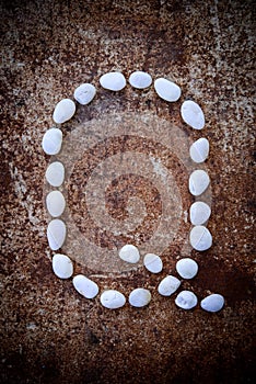 'Q' alphabet made form white stone