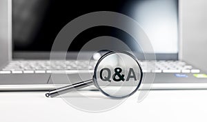 Q concept. QnA, Q and A acronym through magnifier. Technology qa