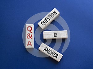 Q and A - Question and Answer. Wooden cubes with words Q and A. Beautiful deep blue background. Business and Q and A concept. Copy