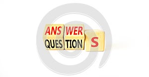 Q and A questions and answers symbol. Turned wooden cubes and changed the word questions to answers. Beautiful white background,