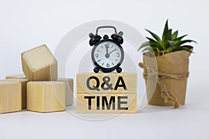 Q and A, questions and answers time symbol. Concept words `Q and A time` on wooden blocks on a beautiful white background. Black