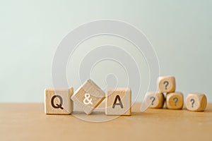 Q and A text , abbreviation of question and answer, and blurred question mark on wooden cube block