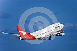 Qantas Boeing 747 jet in flight with landing gear.