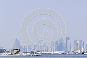 Qatar, Doha, traditional wooden Arab dhow in front of the skyscrapers photo