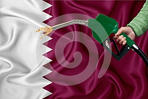 QATAR flag Close-up shot on waving background texture with Fuel pump nozzle in hand. The concept of design solutions. 3d rendering
