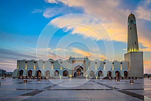 Qatar Grand Mosque exterior view at sunset with clouds in the sky