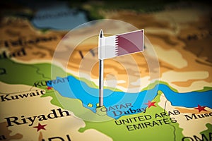 Qatar marked with a flag on the map photo