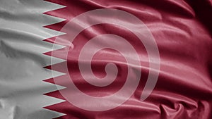 Qatari flag waving in the wind. Close up of Qatar banner blowing soft silk