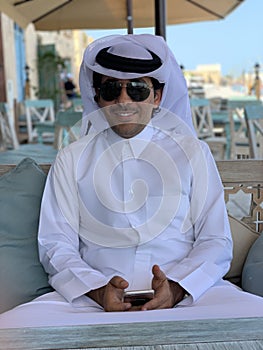 Qatari local in Traditional white outfit with turban