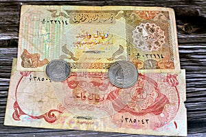 Qatari Money, money background of old coins and banknotes of riyals of different eras, old vintage retro Qatar money coin and