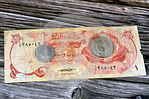 Qatari Money, money background of old coins and banknotes of riyals of different eras, old vintage retro Qatar money coin and