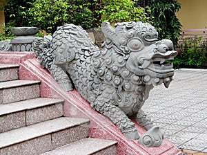 Qilin small dragon statue at temple stairs photo