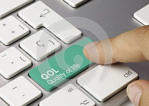 QOL Quality of life - Inscription on Green Keyboard Key