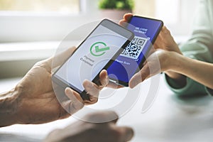 Qr code payment - person paying with mobile phone