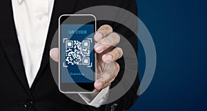 QR code scanning payment and verification. Businessman holding mobile smart phone scan QR code on screen