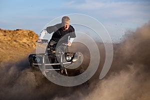 Quad ATV kicking up dust