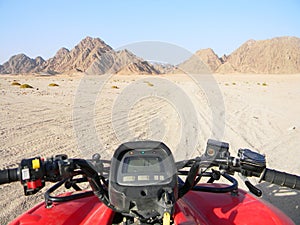 Quad bike in the desert race. All terrain vehicle or quadricycle view in the desert road.