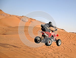 Quad bike jumping in the desert