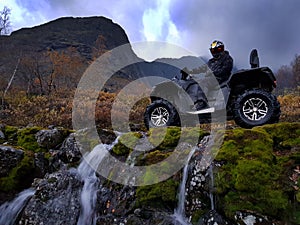 Quad bike in the mountains in the autumn day