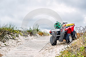 Quad bike parked on the sandy pathway