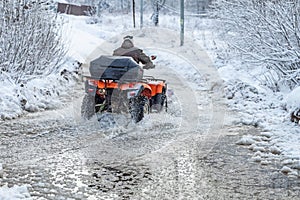 quad bike in the spring on puddles and ice