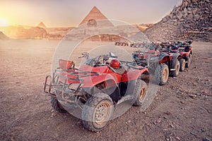 Quad bikes ATV safari in desert background Pyramids Sphinx Cairo, Egypt