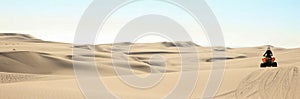 Quad driving people - one happy biker in sand desert dunes, Africa, Namibia, Namib, Walvis Bay, Swakopmund.