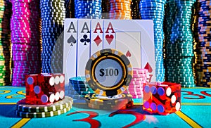 A quad of four aces on the background of a set of colored poker chips on a gaming table in a casino. Playing cards