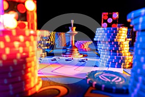A quad of four aces, set chips and dice on gaming table on black background. Playing cards, poker chips, dealer chip and
