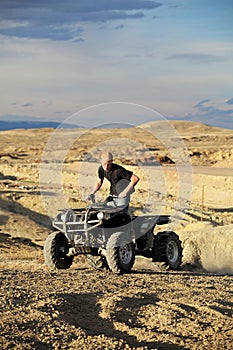 Quad in hills - teen on four wheeler