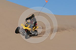 Quad rider in sand dunes bowl