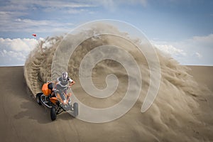 Quad rider in sand dunes roost